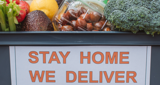 A food basket full of vegetables with the slogan Stay Home We Deliver