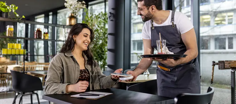 Woman paying in cafe