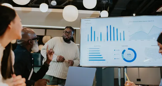People looking at a board during a meeting