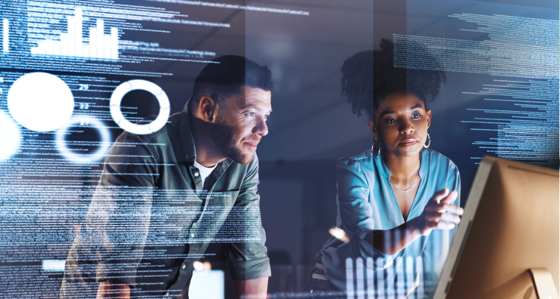 Two colleagues looking a data on a screen