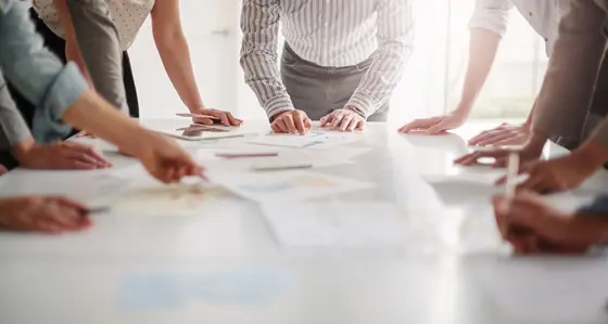 People around a table looking at documents