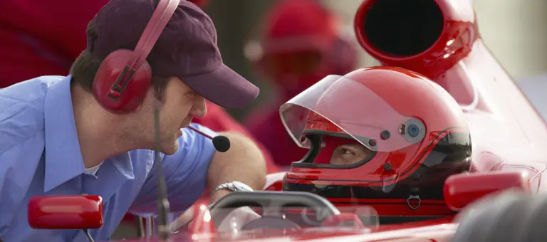 man talking to race car driver