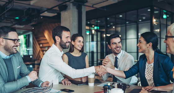 Two smiling people shaking hands