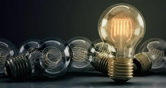 A collection of lightbulbs with one illuminated