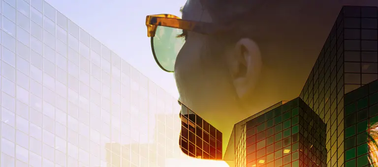 A woman's head superimposed over office buildings