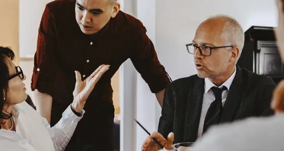 Three people talking during a meeting