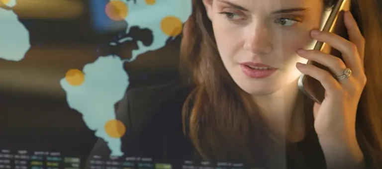 A woman on phone in front of a map with data