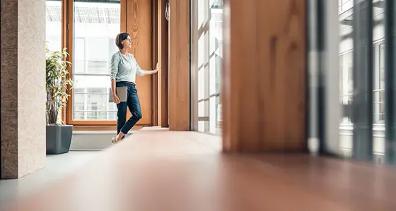 Standing woman opening a door