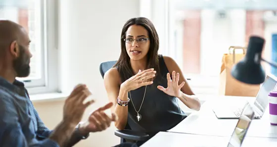 Two people in a conversation at work