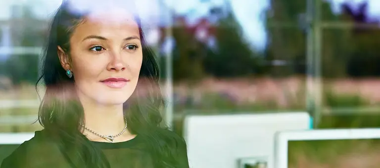 A woman staring out of an office window