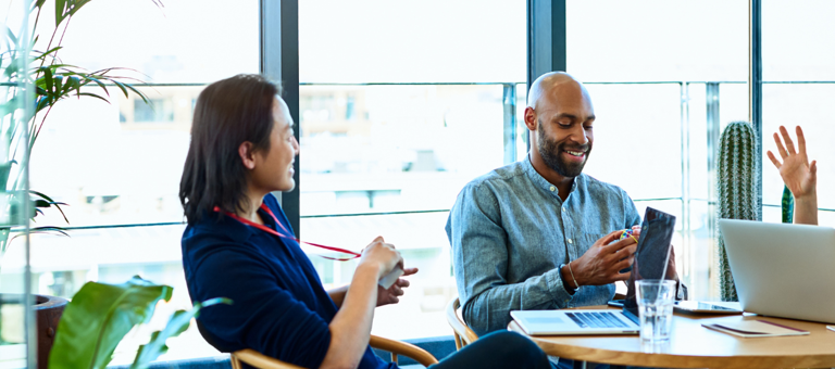 Group discussion at a round table surrounded by plants
