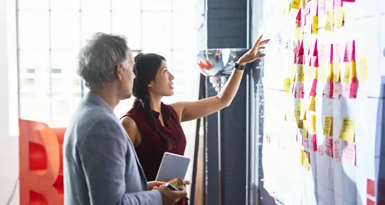 Workplace collaboration man and woman whiteboard