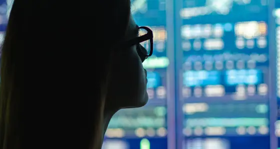 A woman looking at digital screens