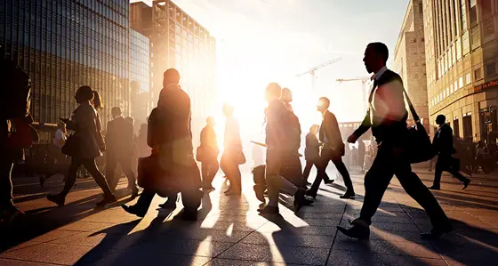 Business people crossing the road in a busy city