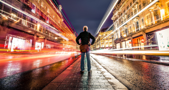 Man in city at night with bright light
