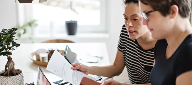Two people looking at a report