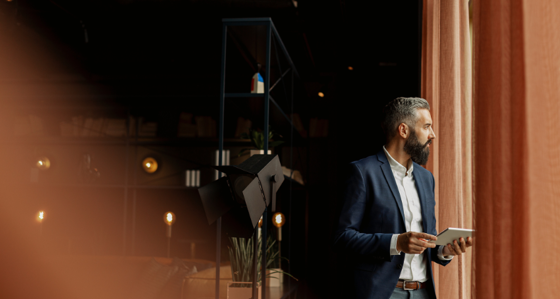 Businessman in cafe holding digital tablet