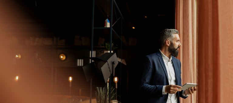 Businessman in cafe holding digital tablet
