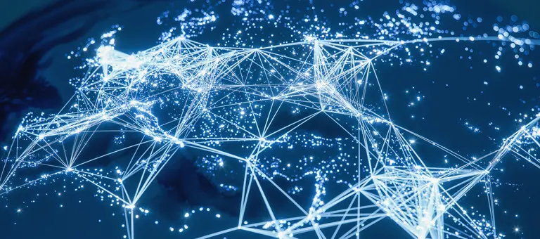 The world lit up at night with cities connected by lines of lights representing networks