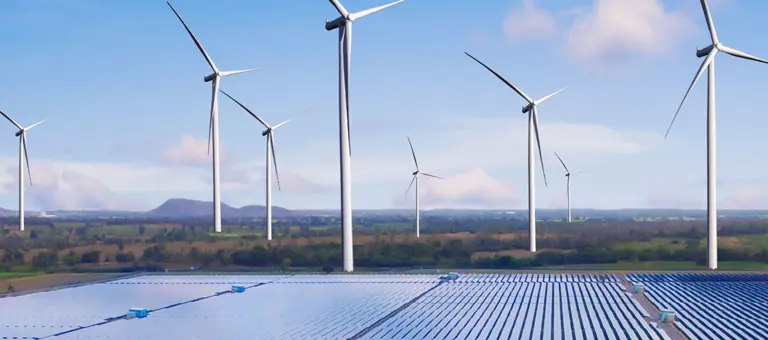 Wind turbines and a solar farm set in the countryside
