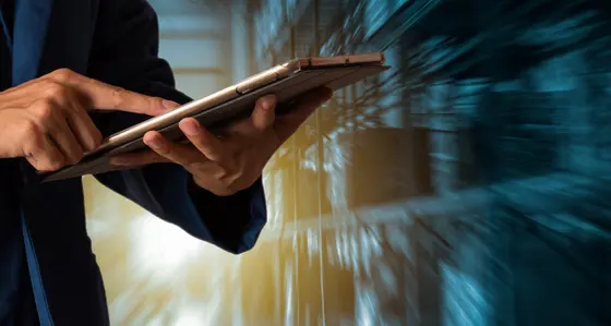 A man with a tablet in a data centre