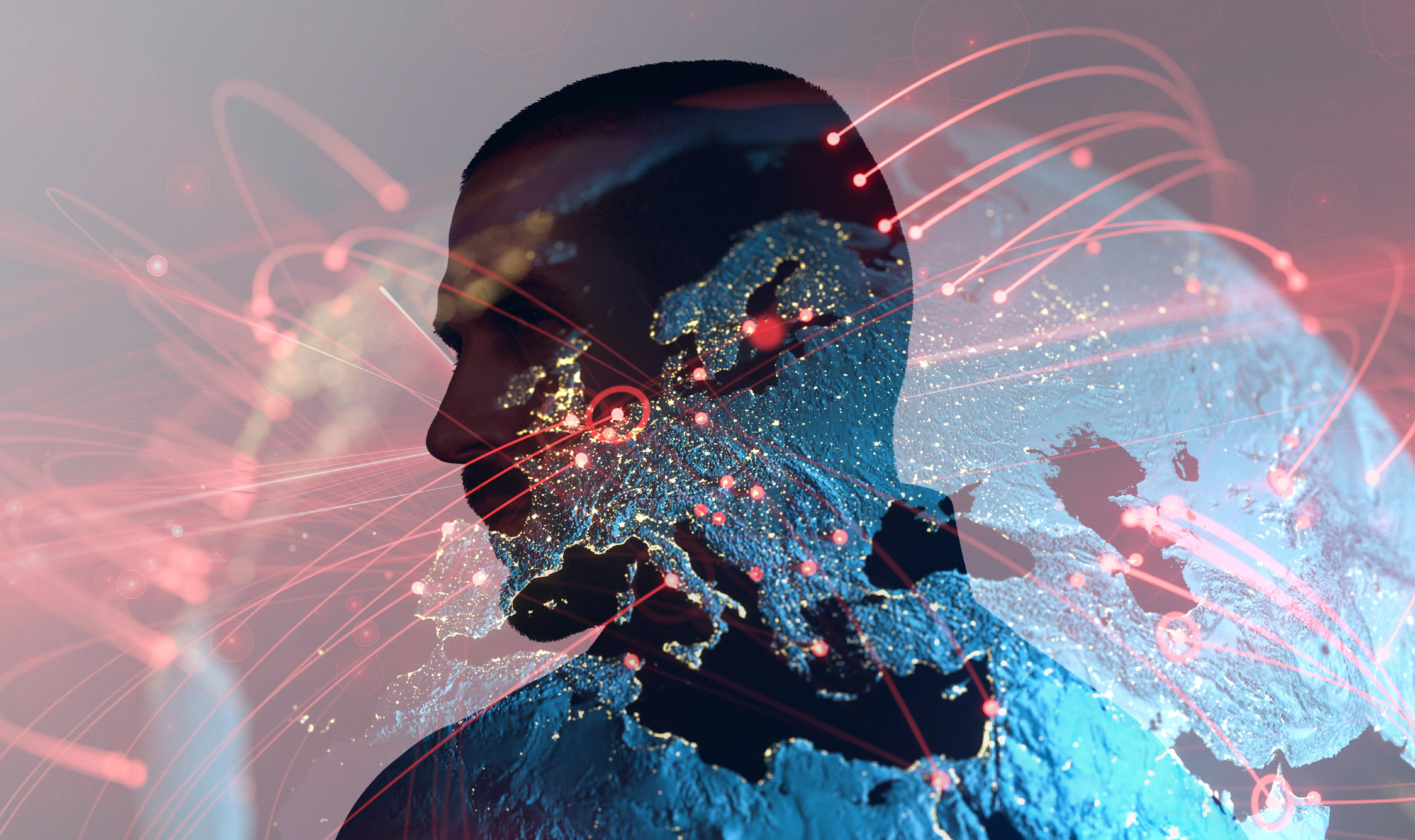 The silhouette of a man's head superimposed over the Earth lit up at night