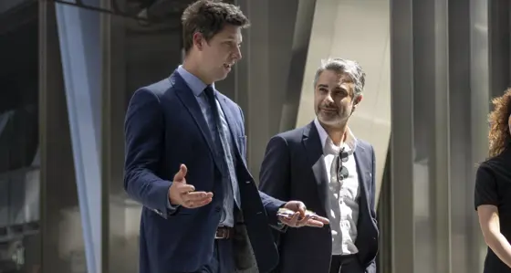 Three professionals in conversation outside an office building