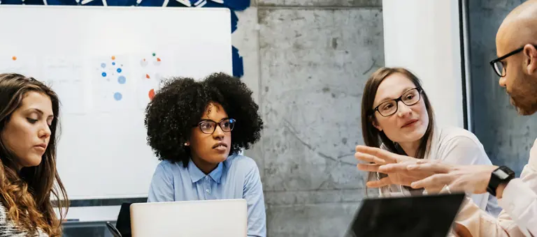 A group of people in a meeting