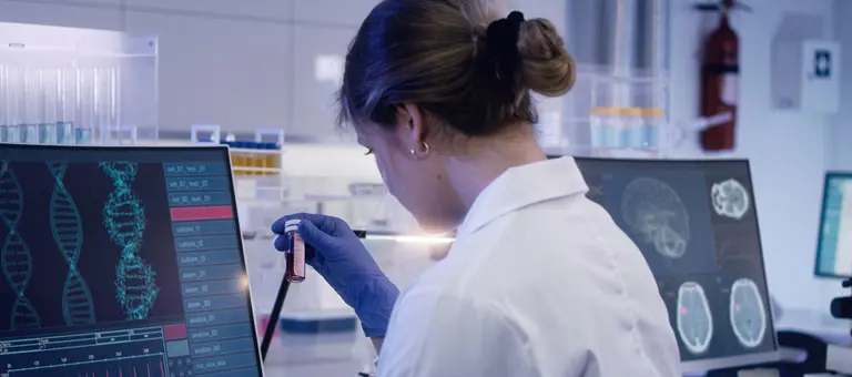A lab technician studying a sample