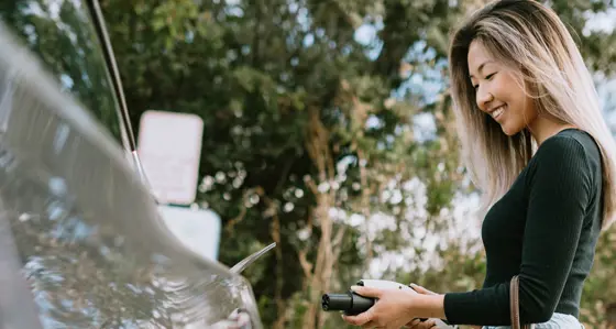 A woman charging her electric car