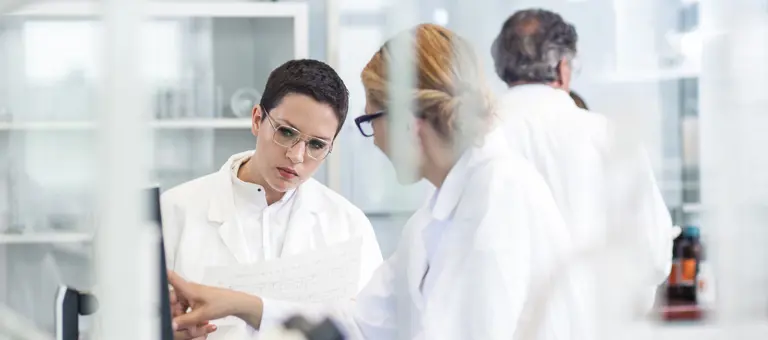 Two laboratory technicians discussing results