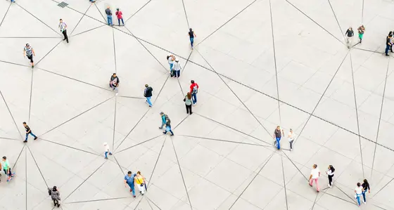 An aerial view of people walking over a triangular-patterned surface