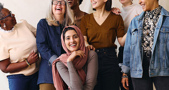 A diverse group of women laughing and smiling
