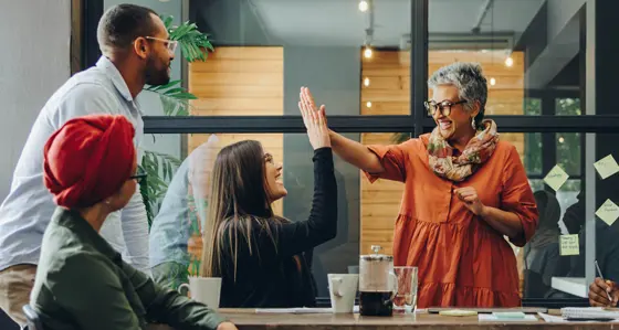 Two colleagues making a 'high five'