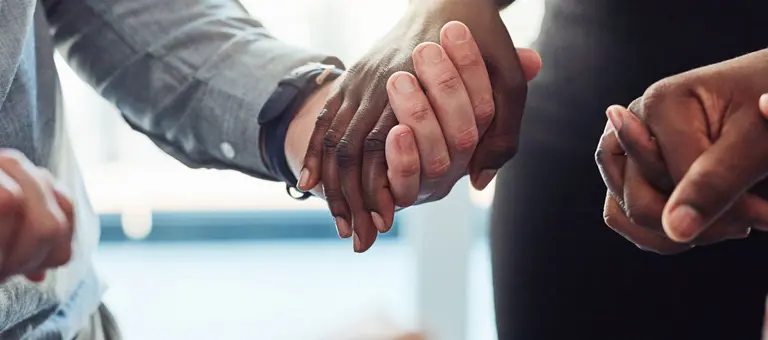 A circle of people holding hands