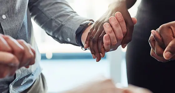 A circle of people holding hands