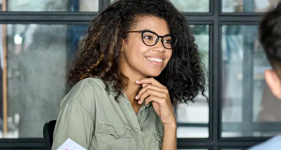 A smiling woman in a meeting