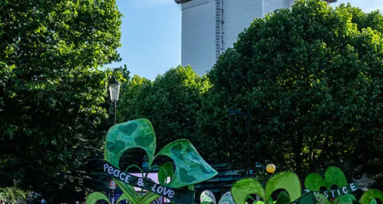 A rally seeking justice for Grenfell with the tower behind showing a huge green heart