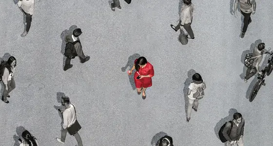 Woman walking among other people