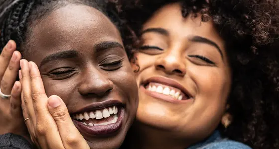 Two girl friends are hugging