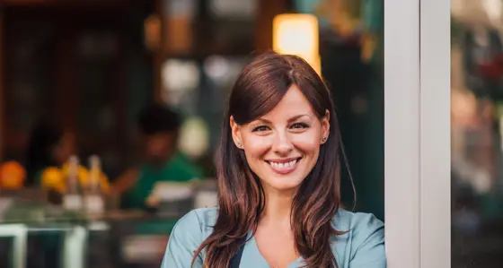 Waitress smiling outside a cafe
